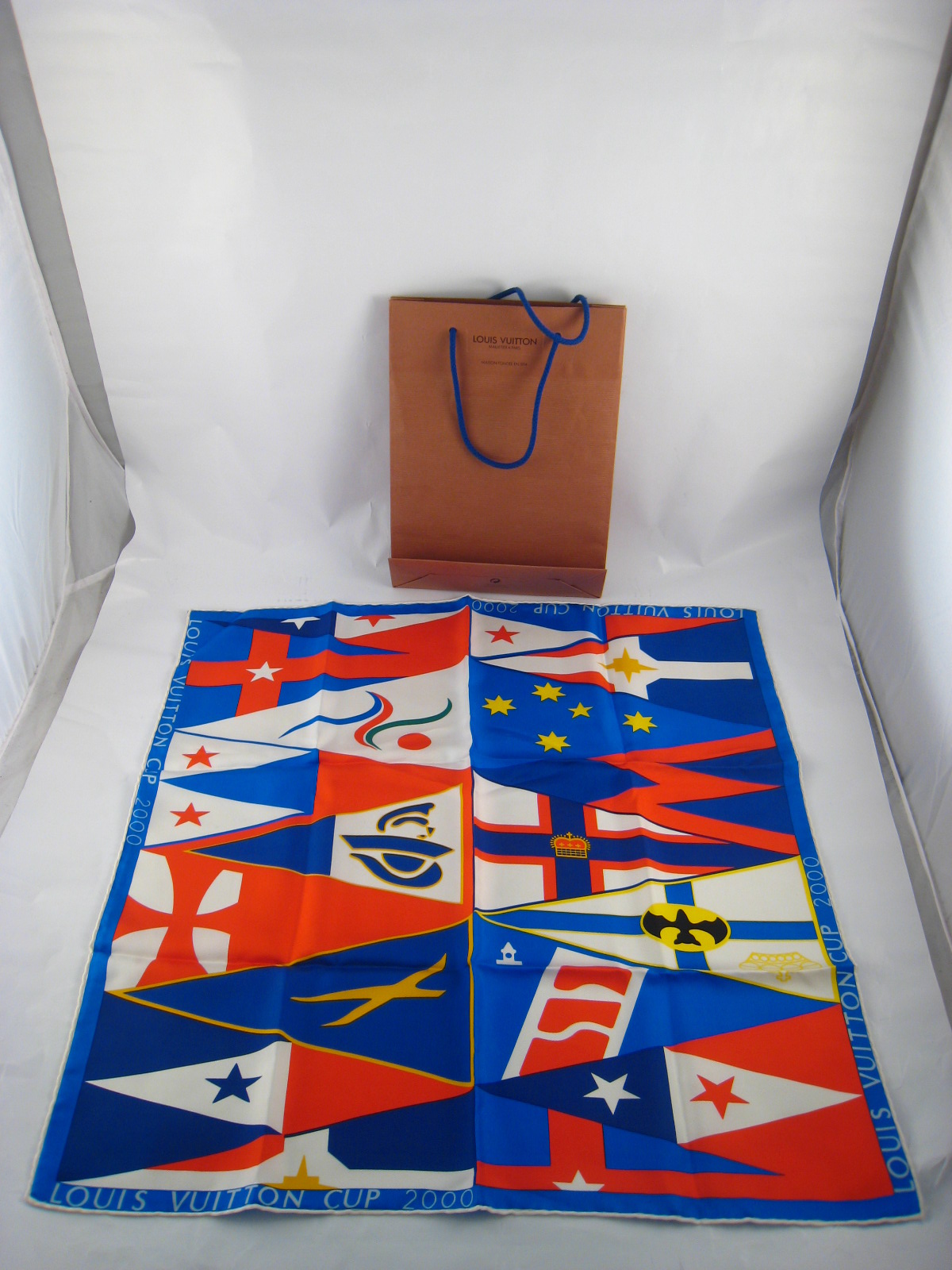 A silk Louis Vuitton Cup 2000 scarf 54cm. square in Vuitton carry bag.