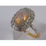 A yellow metal (tests 18 carat gold) opal and diamond ring, opal approx 10 x 7mm,