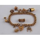 A 9 carat gold charm bracelet with eight charms, gross weight approx 39.4 gms.
