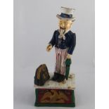 An Uncle Sam cast iron push button mechanical money box. Ht.27cm.