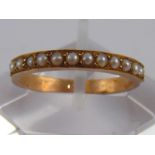 A yellow metal (tests 18 carat gold) seed pearl ring, size M, 1.5 gms.