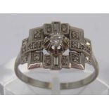 A white metal (tests 18 carat gold) Art Deco style diamond ring, size L, 2.3 gms.