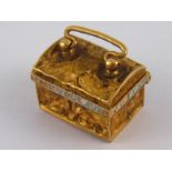A French gold and enamel treasure chest charm, enamel A/F, approx 15mm long, 2.7 gms.