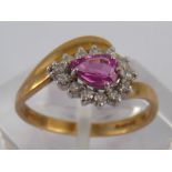 A 9 carat gold ruby and diamond ring, ruby approx 6 x 4mm, ring size N ½, 2 gms.