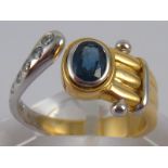 An 18 carat gold sapphire and diamond ring, sapphire approx 5.6 x 4mm, ring size N, 7.4 gms.
