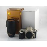 A Nikon F60 camera together with a Nikkor 18-200mm. lens. Both boxed, apparently unused.