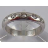 A white metal (tests 18 carat gold) five stone diamond ring,