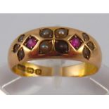 An antique 15 carat gold ruby and seed pearl ring, hallmarked Birmingham 1889, ring size N, 4.1 gms.