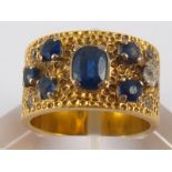 A yellow metal (tests 18 carat gold) sapphire and diamond ring, principal sapphire approx 5.6 x 4.