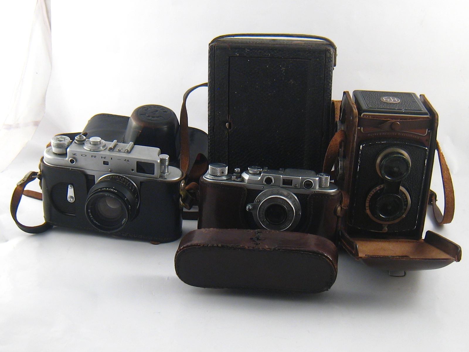 Four cameras, being a Rolleicord in ER case, a Soviet 35mm.