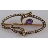 An Art Nouveau 15 carat gold amethyst and seed pearl brooch, approx 38mm wide, 3.5 gms.