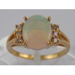 A yellow metal (tests 14 carat gold) opal and diamond ring, opal approx 9 x 7mm, ring size K, 2.