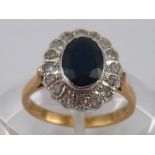 A 9 carat gold sapphire and diamond ring, sapphire approx 8 x 6mm, ring size M, 3.5 gms.