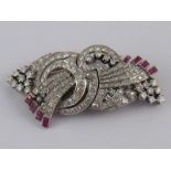A white metal (tests 18 carat gold and platinum) diamond and ruby double clip brooch,