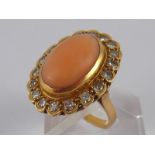 A French hallmarked 18 carat gold coral and diamond ring, coral approx 15 x 10mm, ring size L, 7.
