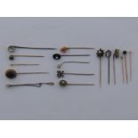 A mixed lot comprising sixteen untested stick / tie pins, including untested pearls, coral,