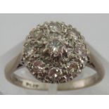 A white metal (tests platinum) diamond cluster ring, estimated total diamond content approx 0.