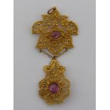 A filigree yellow metal (tests gold) and cabochon amethyst Eastern pendant, approx 8cm drop, 13.