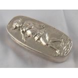 A George IV oval silver table snuff box, the lid with embossed figure of a jester playing a pipe. W.