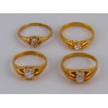 A mixed lot comprising three antique 18 carat gold diamond solitaire rings and one paste,