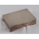 A silver cigarette box by SJR, Birmingham, 1965, on stepped feet,