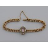 A yellow metal (tests 15 carat gold) pink topaz and seed pearl bracelet, marked 15, topaz approx 11.