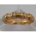 A yellow metal (tests 18 carat gold) “bamboo” design diamond ring, marked 750 and CLM maker's mark,