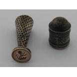 A silver cylindrical nutmeg grater with domed top and steel grille, cover missing,