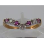 A 9 carat gold ruby and diamond “wishbone” ring, size O, 1.8 gms.