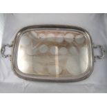 A silver plated two handled tray with gadrooned border and shell and leaf capped handles. 39.5x70cm.