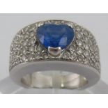 A white metal (tests 18 carat gold) sapphire and diamond ring,