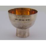A modern planished silver goblet by MBS, London, 2005, on drum-shaped foot, gilt interior 6.5 cm.