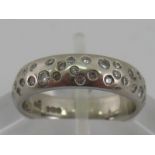 A platinum diamond set band ring, size J, 7.2 gms.