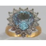 A yellow metal (tests 18 carat gold) aquamarine and diamond ring,