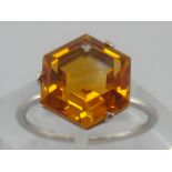 A white metal (tests 18 carat gold) citrine ring, citrine approx 11mm wide, ring size N,2.8 gms.