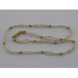 A seed pearl necklace with yellow metal (tests 18 carat gold) clasp and beads,