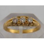 An 18 carat gold diamond three stone ring,