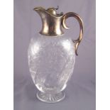 A late Victorian silver mounted glass claret jug with flying scroll handle,