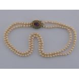 A two row cultured pearl necklace with a yellow metal (tests 18 carat gold) amethyst and turquoise