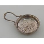 A George III silver lemon strainer with beaded rim and lyre shaped handle by Thomas Daniell,