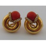 A fine pair of coral and diamond ear clips, stamped 750 for 18 carat gold,