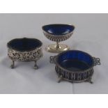 Three various silver open condiment pots, each with blue glass liner.