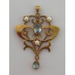 A modern Edwardian style 9 carat gold, aquamarine and seed pearl pendant, of open work design,