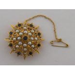 A 9 carat gold, seed pearl and sapphire star brooch, hallmarked London 1968, 30mm diameter, 7.