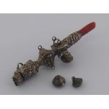 A Georgian child's silver rattle with coral teether and one bell, plus two detached..