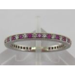 A Tiffany platinum, ruby and diamond eternity ring, signed to inner shank, 2mm width, finger size T,