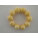 A white amber bracelet, composed of ten large round beads, each 21mm,