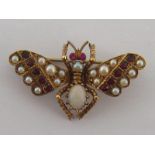 A late Victorian garnet, ruby, seed pearl and opal insect brooch,