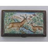 A Persian silver cigarette case, the lid with enamel scene of deer, ibex and birds.