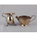 A silver cream jug of baluster form on 3 shell-capped feet, Birmingham, 1912, 8 cm.